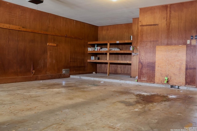 garage featuring wood walls