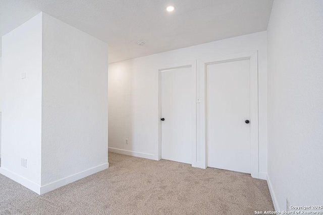 unfurnished bedroom with carpet, baseboards, and recessed lighting