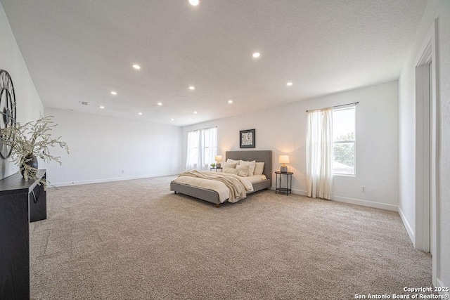 bedroom featuring light carpet, a textured ceiling, baseboards, and recessed lighting