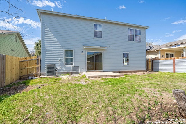 back of property featuring central AC unit, a lawn, a patio area, and a fenced backyard