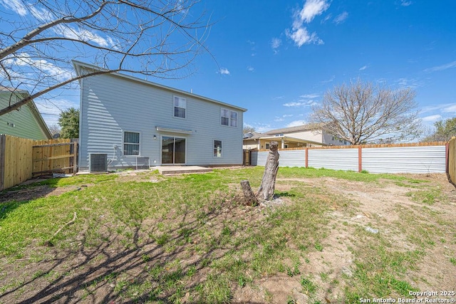 rear view of house with a patio, a fenced backyard, cooling unit, and a lawn