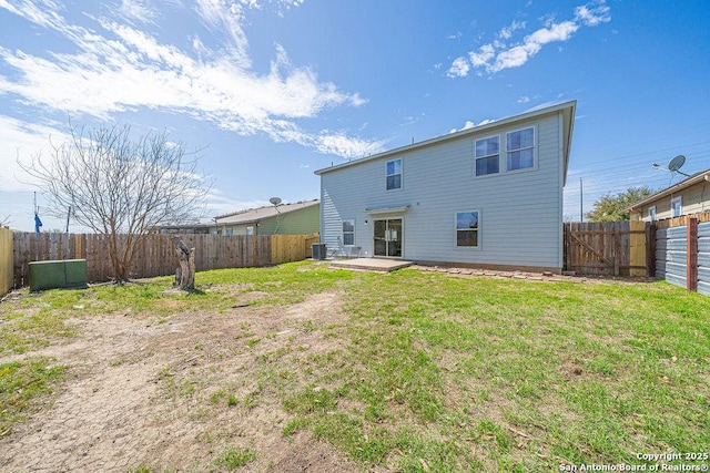 rear view of property featuring cooling unit, a fenced backyard, and a yard