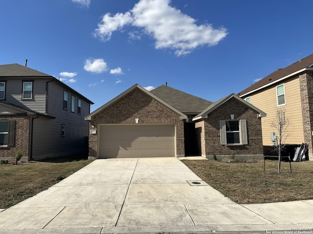 view of front of property with concrete driveway, brick siding, an attached garage, and a front yard