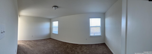 carpeted empty room featuring a healthy amount of sunlight and baseboards