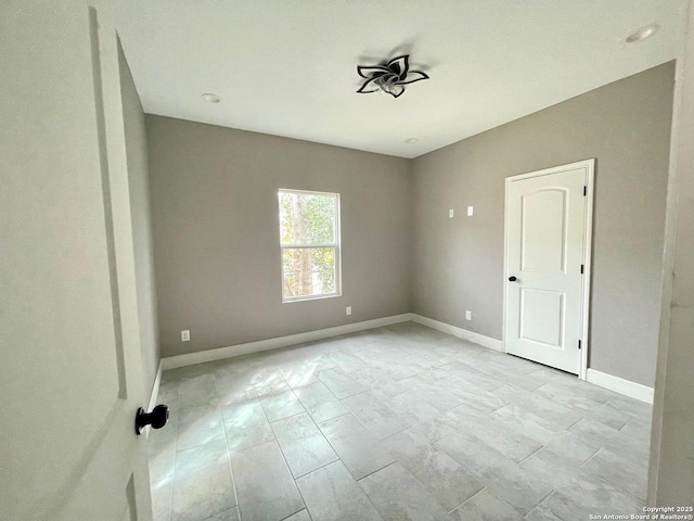 empty room featuring baseboards