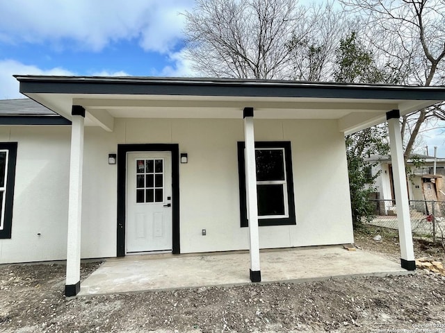 doorway to property featuring fence