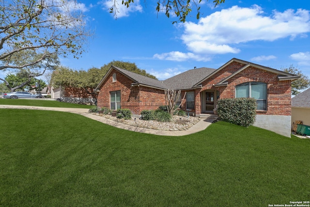 ranch-style house with brick siding, a front lawn, and roof with shingles