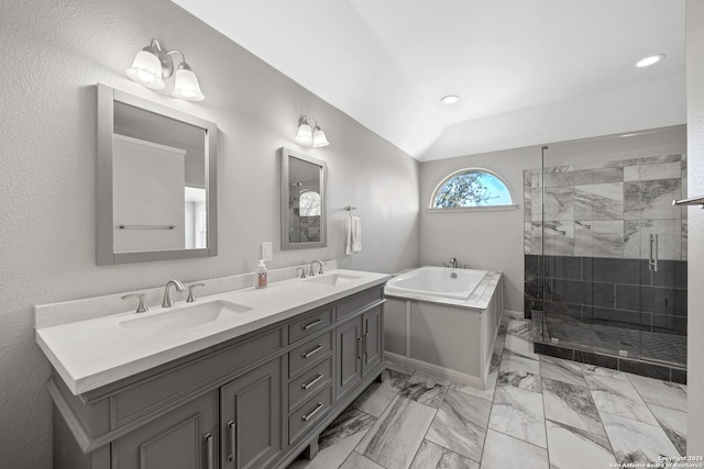 bathroom with marble finish floor, a garden tub, a sink, and a shower stall