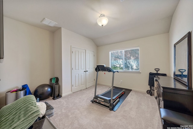 workout room with vaulted ceiling, carpet flooring, visible vents, and baseboards