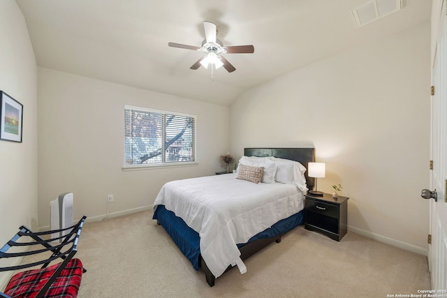 bedroom with light carpet, baseboards, and vaulted ceiling