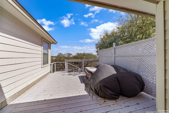 wooden deck featuring a grill