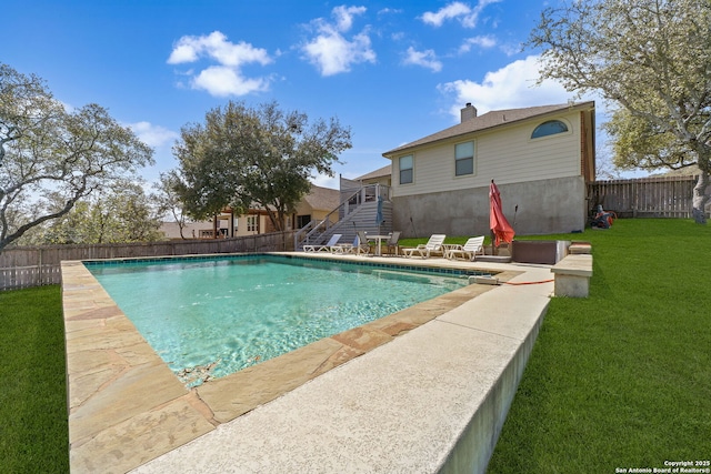 view of pool with stairway, a fenced backyard, a lawn, and a fenced in pool