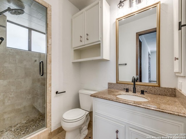 full bath with toilet, a shower stall, and vanity