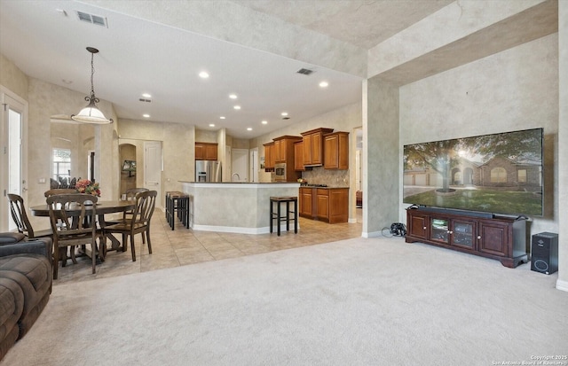 living area with arched walkways, recessed lighting, light colored carpet, and visible vents