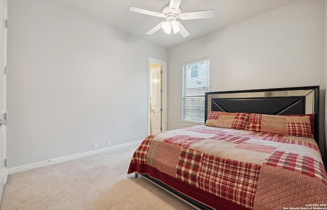 carpeted bedroom with ceiling fan and baseboards