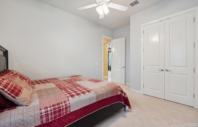 bedroom with a closet, light colored carpet, visible vents, a ceiling fan, and baseboards