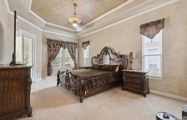 bedroom featuring light carpet, a tray ceiling, ornamental molding, and baseboards