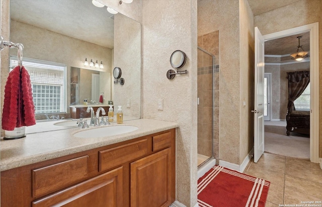 full bathroom with a stall shower, plenty of natural light, tile patterned flooring, and vanity