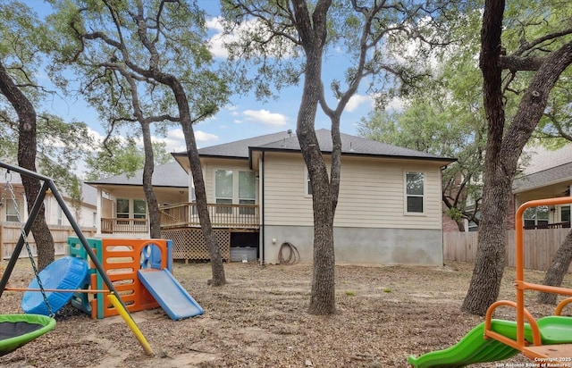 view of jungle gym with a fenced backyard and a deck