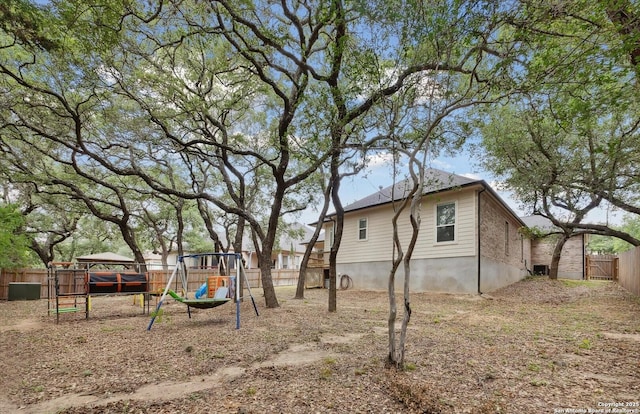 view of yard featuring a playground and fence