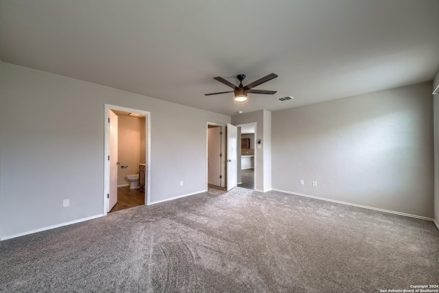 unfurnished bedroom with carpet floors, visible vents, ceiling fan, ensuite bath, and baseboards