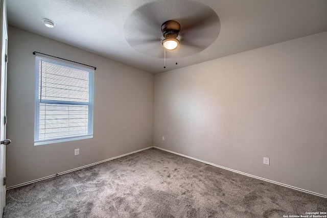 empty room with ceiling fan and carpet flooring