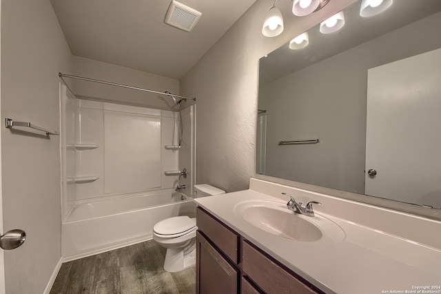 full bath with visible vents, toilet, vanity, shower / tub combination, and wood finished floors