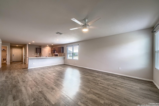 unfurnished living room featuring recessed lighting, a ceiling fan, visible vents, baseboards, and dark wood-style floors