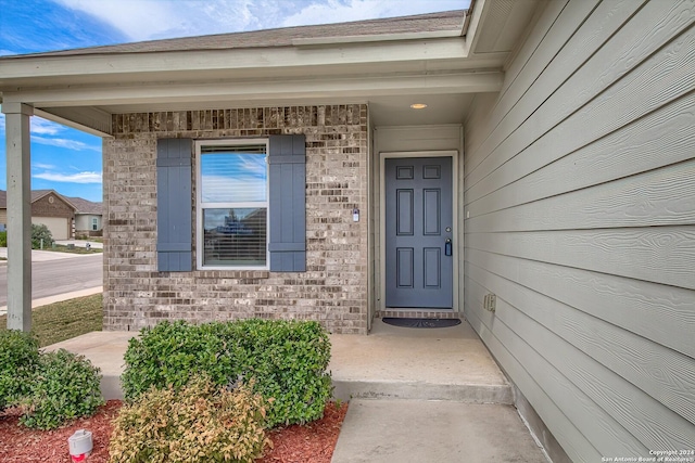 entrance to property with brick siding