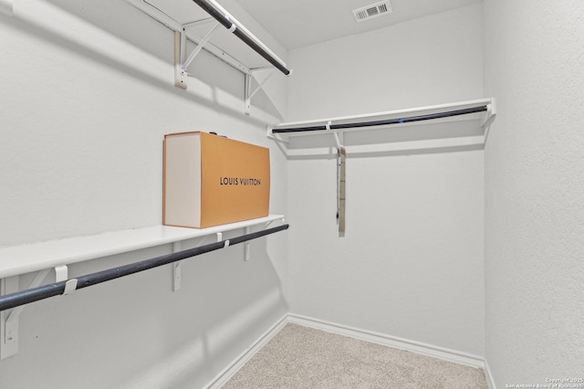 walk in closet featuring carpet and visible vents