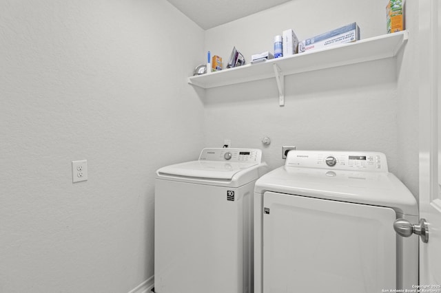 washroom featuring laundry area and washing machine and clothes dryer