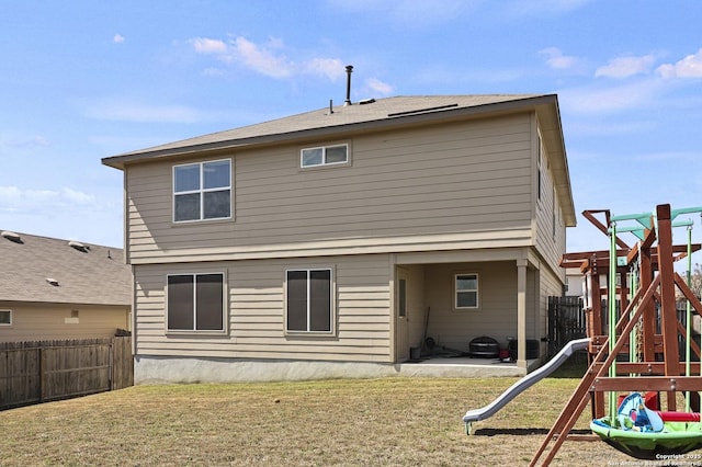 back of property with a patio area, a yard, a playground, and a fenced backyard