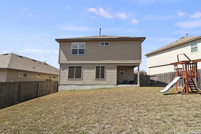 back of property featuring a patio area, a fenced backyard, a lawn, and a playground