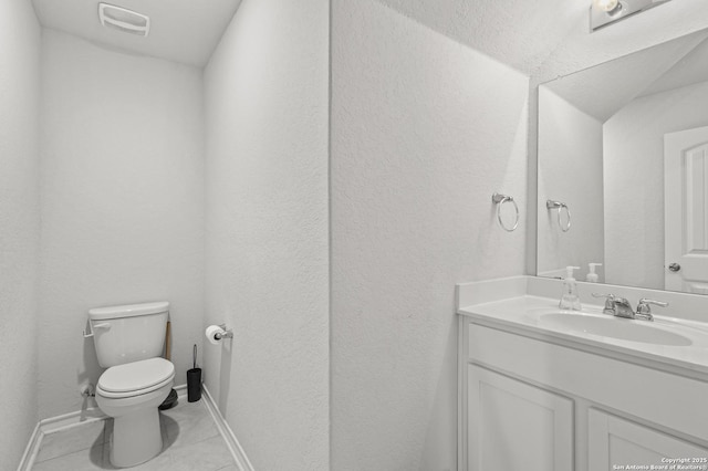 bathroom with visible vents, toilet, vanity, baseboards, and tile patterned floors