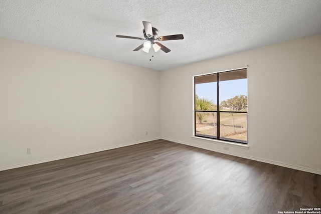 empty room featuring a textured ceiling, ceiling fan, dark wood-type flooring, and baseboards