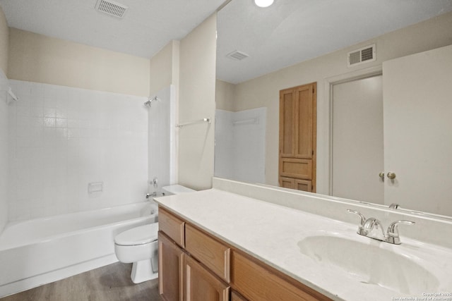 full bathroom with shower / bath combination, visible vents, toilet, and wood finished floors