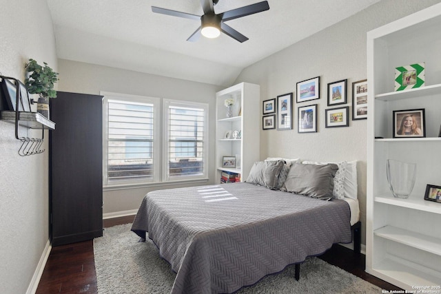 bedroom with lofted ceiling, wood finished floors, a ceiling fan, and baseboards