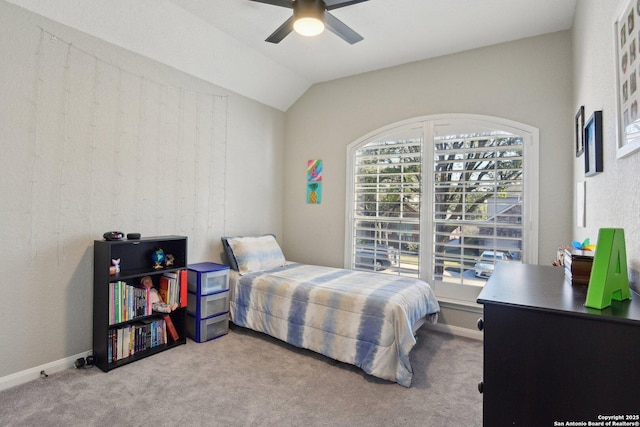 bedroom with carpet floors, lofted ceiling, baseboards, and a ceiling fan