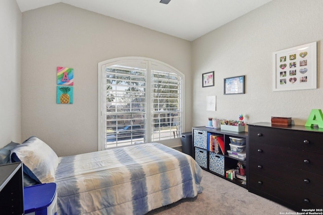 bedroom featuring carpet and vaulted ceiling