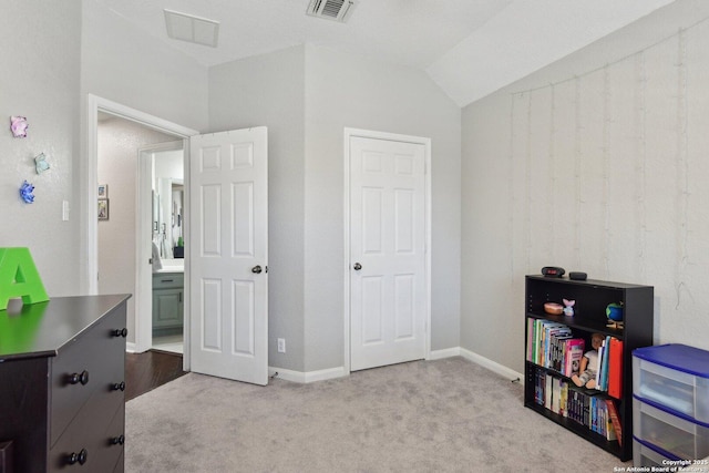 carpeted bedroom featuring baseboards, visible vents, and vaulted ceiling