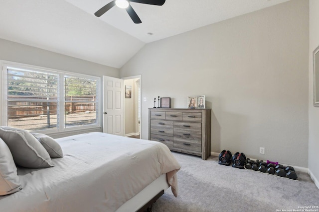 carpeted bedroom with ceiling fan, baseboards, and vaulted ceiling