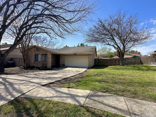 view of front facade with a front lawn, concrete driveway, fence, and an attached garage