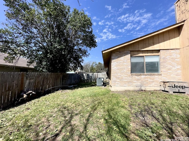 view of yard featuring central air condition unit and a fenced backyard