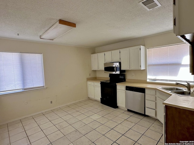 kitchen featuring light countertops, visible vents, appliances with stainless steel finishes, white cabinets, and a sink