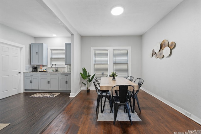 dining area with dark wood finished floors and baseboards