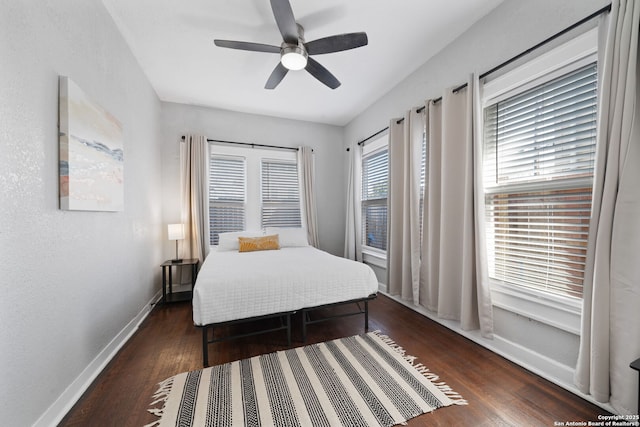 bedroom with baseboards, wood finished floors, and a ceiling fan