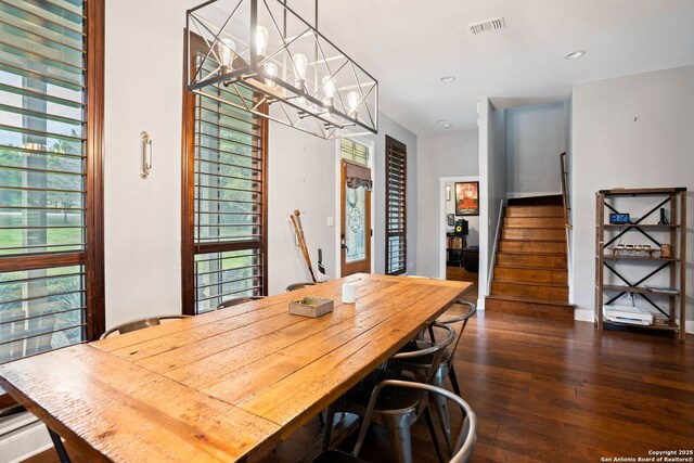 dining space featuring visible vents, dark wood-style floors, recessed lighting, stairway, and a chandelier