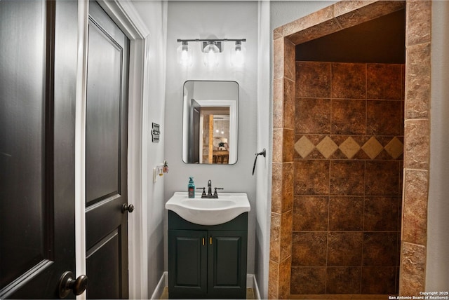 full bath featuring vanity and tiled shower