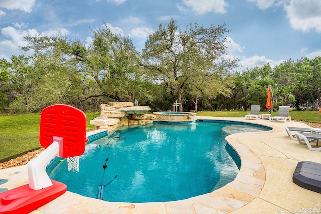view of pool with a yard, a patio area, and a pool with connected hot tub