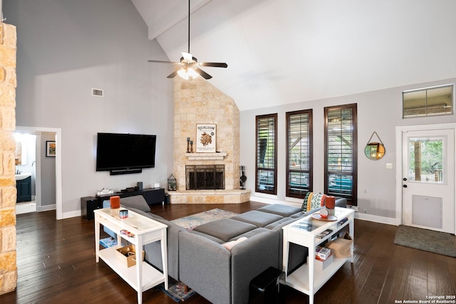 living area with visible vents, high vaulted ceiling, hardwood / wood-style floors, and a fireplace